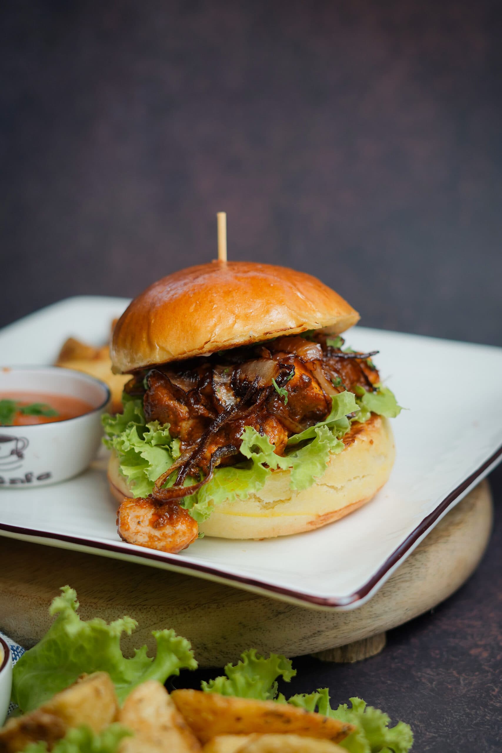 HiCafe's signature chicken burger with potato wedges